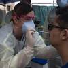 Medical personnel performing Covid nasal swap test